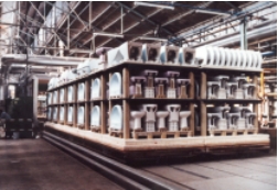 Pieces of sanitaryware - wash basins and toilets - stacked on a kiln car 
