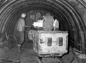 WBB mining machine operated by Ivor Basset in an adit tunnel supported by steel arches
